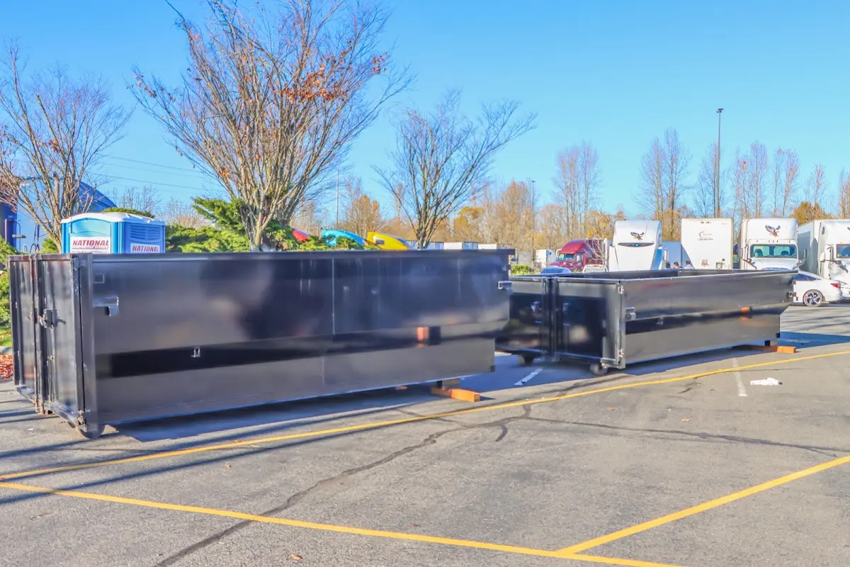 Professional dumpster rental service with roll-off container on residential driveway in St. Gabriel